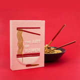 Clutch titled 'The Art of Ramen' with a bowl of ramen and chopsticks on a red background